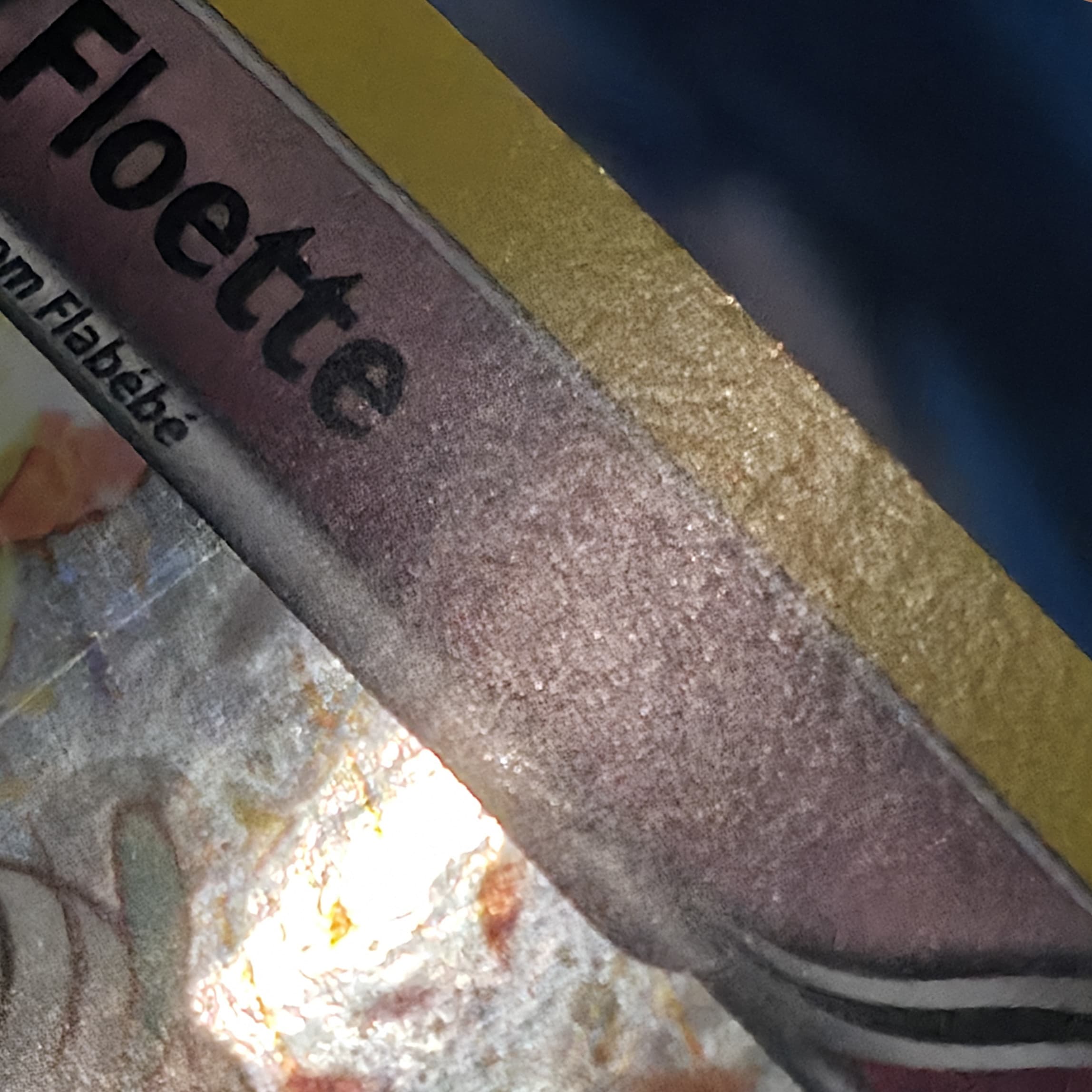 Floette Pokemon card after crease repair — crease softened and surface presentation improved