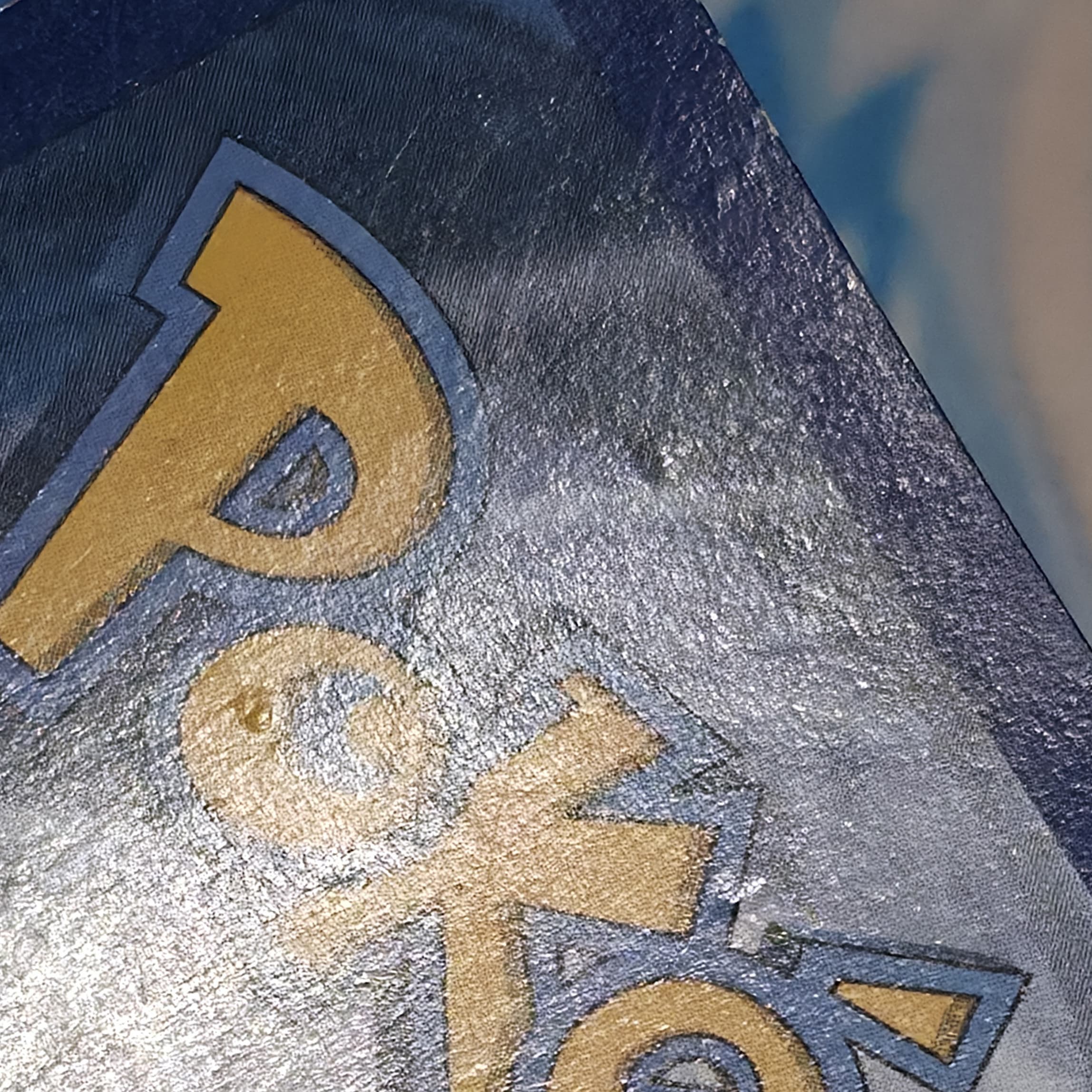 Gengar Pokemon card back after deep dent repair — dents reduced and smoother surface