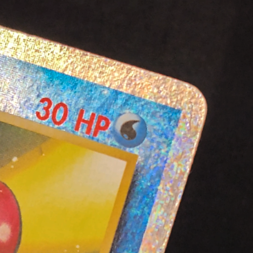 Tentacool Pokemon card after crease repair — energy symbol and border look smoother